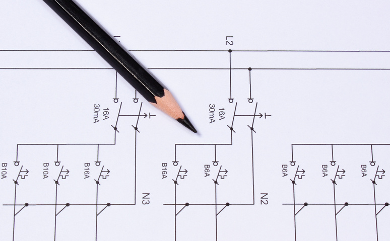 Pencil lying on electrical diagrams